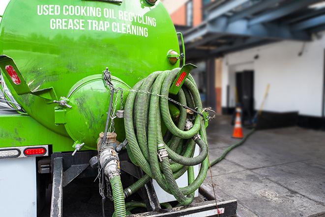 a grease trap pumping service in action at a commercial building in Euless, TX